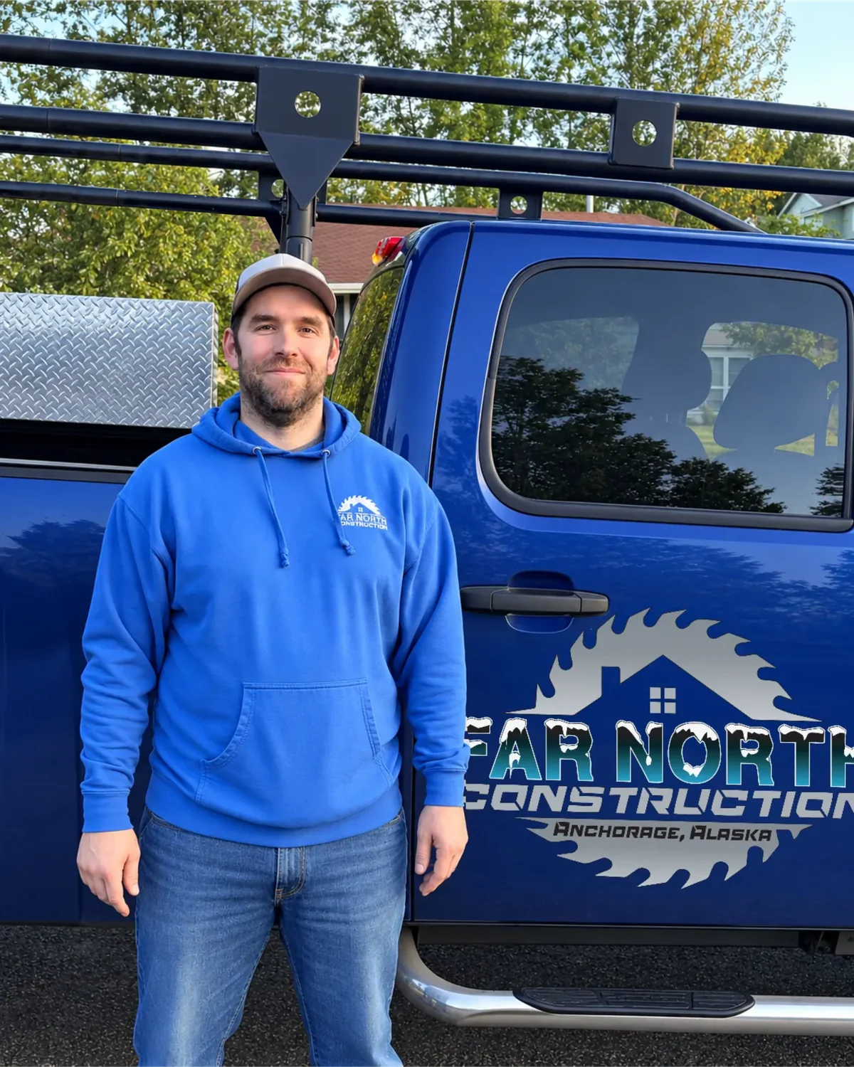 Kevin Ambro, owner of Far North Construction, beside the company’s blue work truck